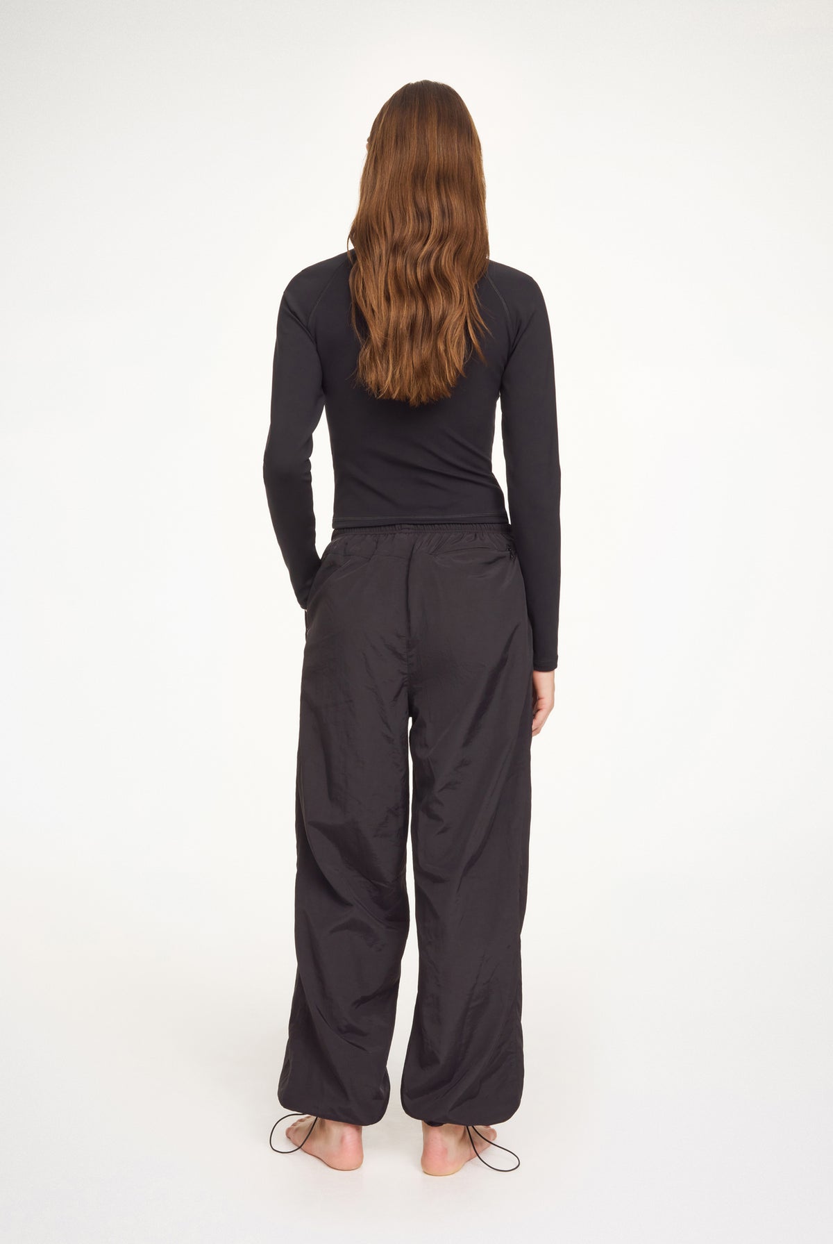 Person wearing a black outfit on a white background