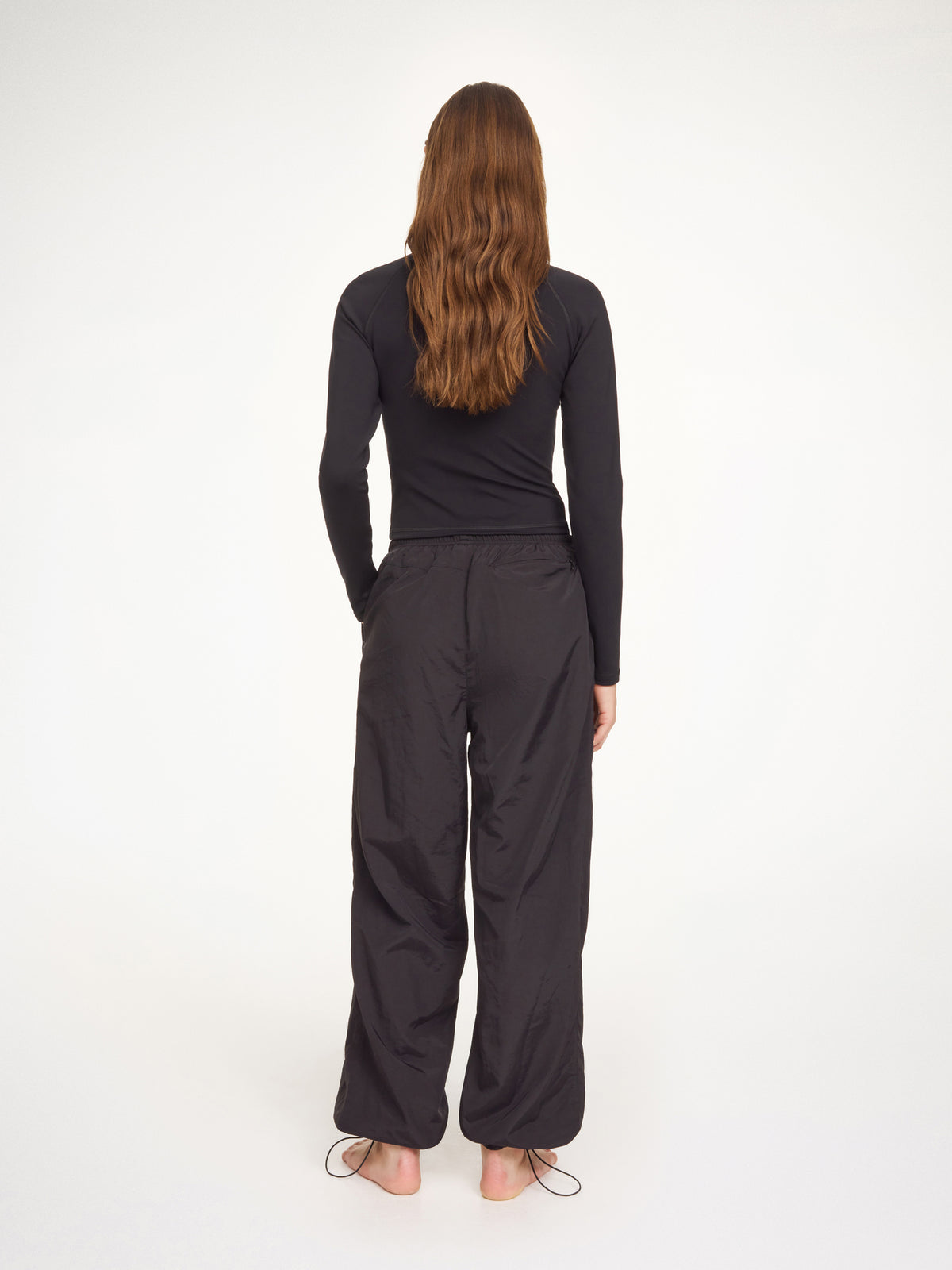 Person wearing a black outfit on a white background