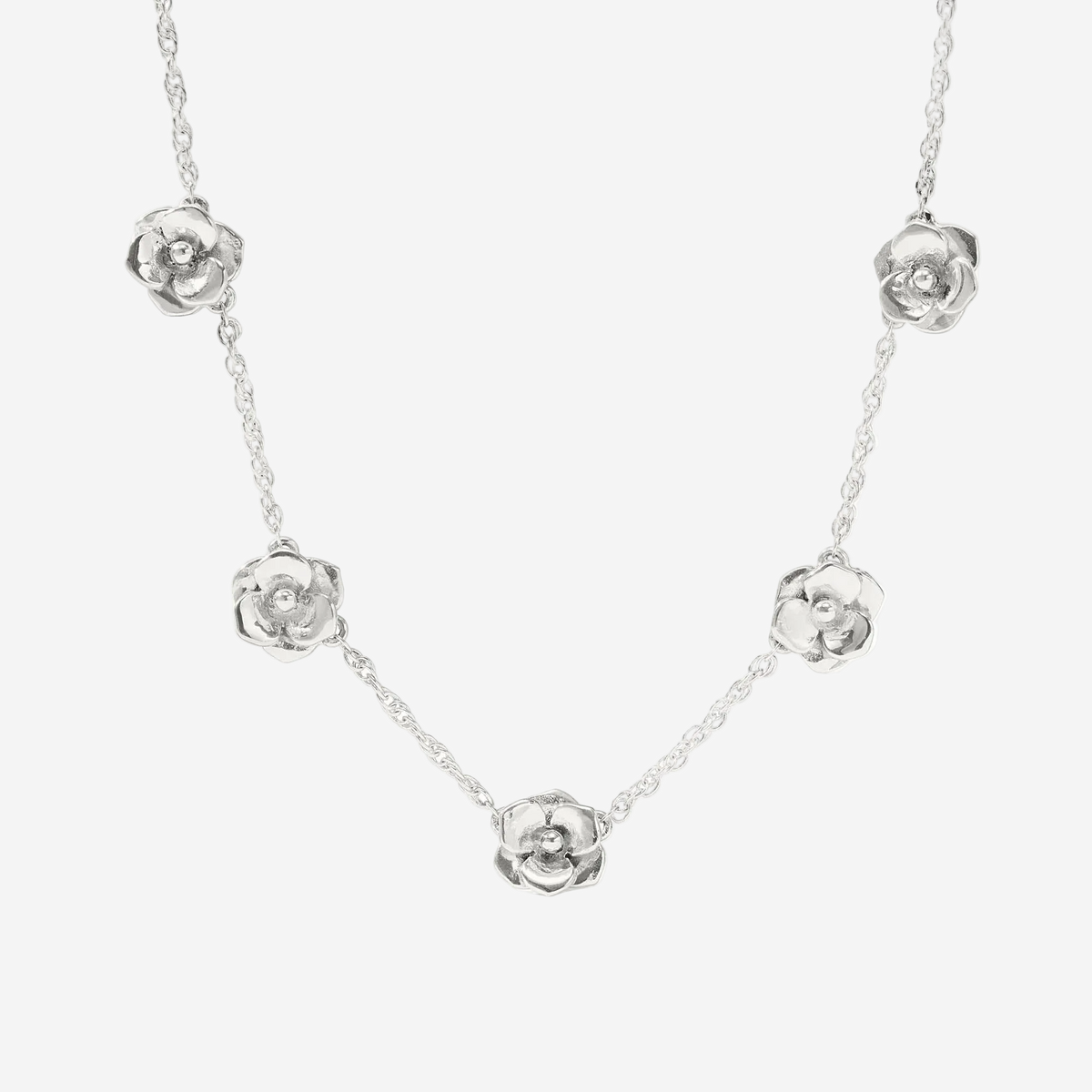 Silver necklace with floral pendants on a white background