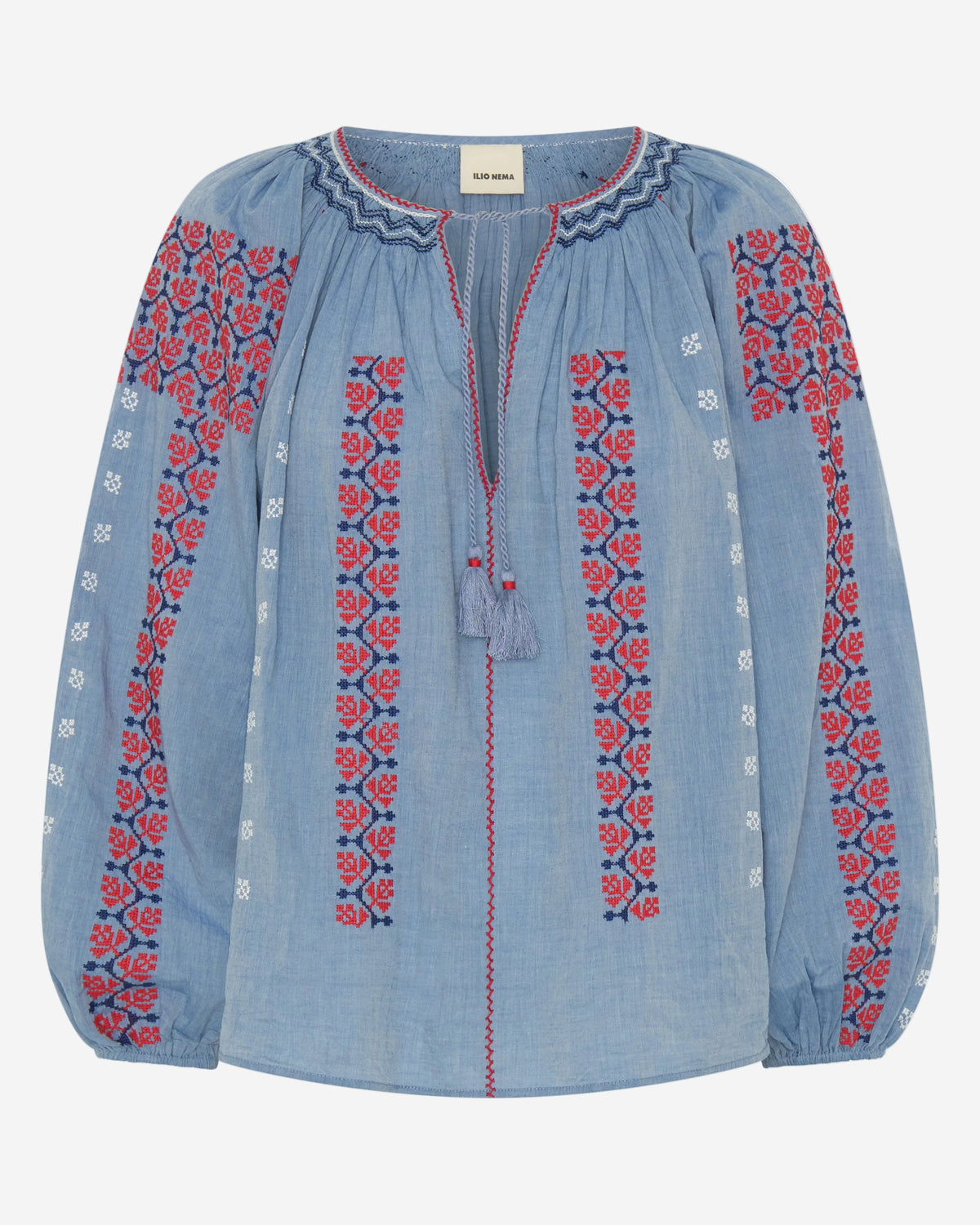 Blue blouse with red and white floral embroidery on a white background