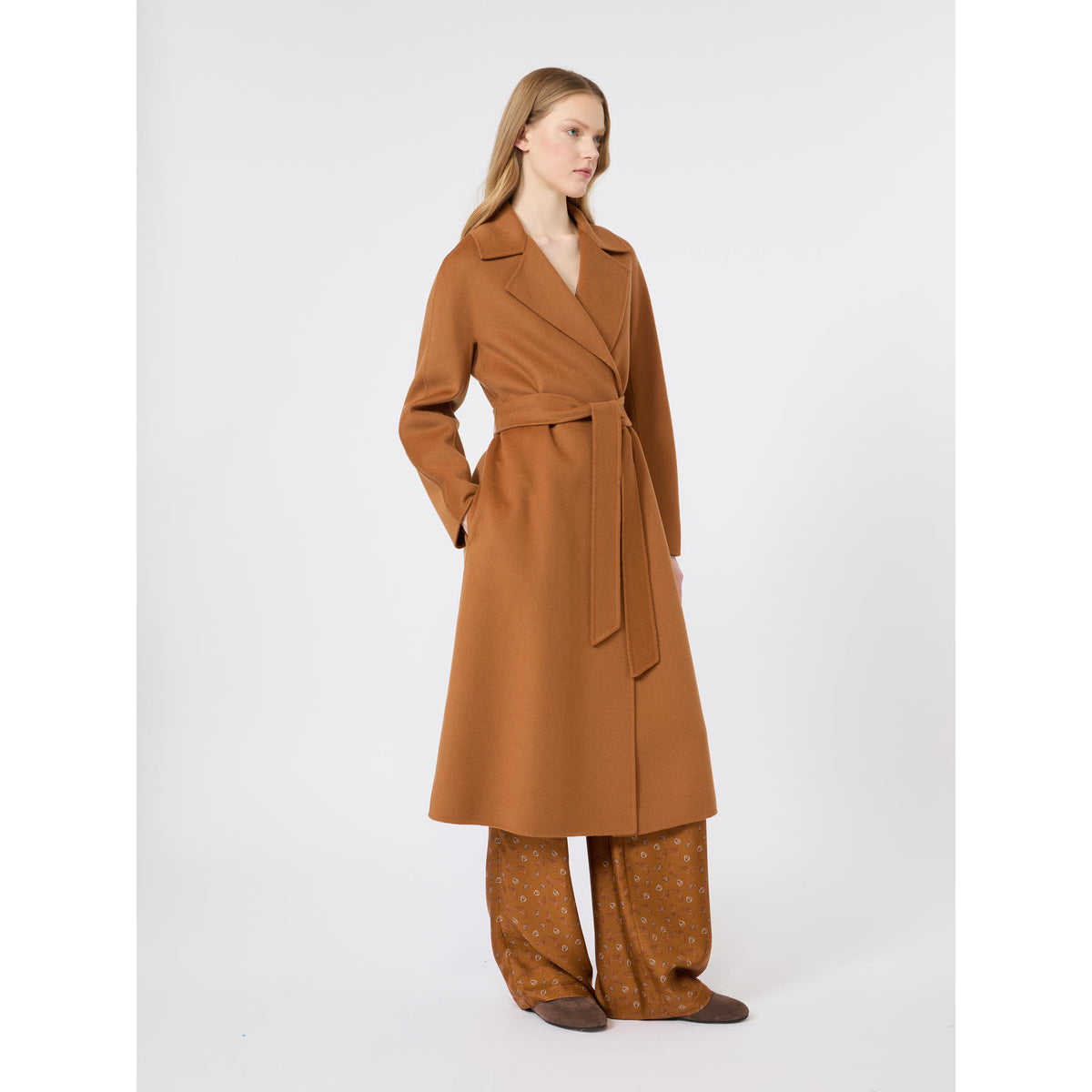 Woman wearing a brown trench coat on a white background