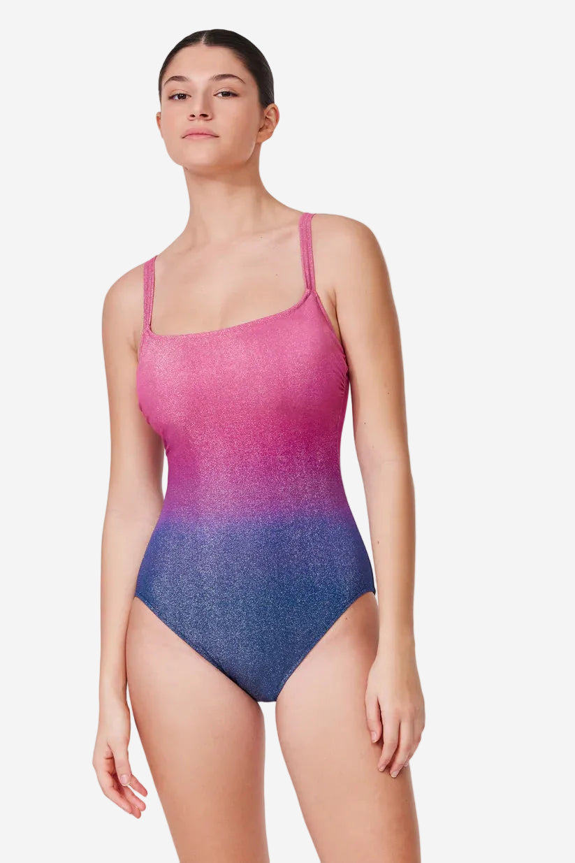 Woman wearing a pink and blue gradient swimsuit on a white background