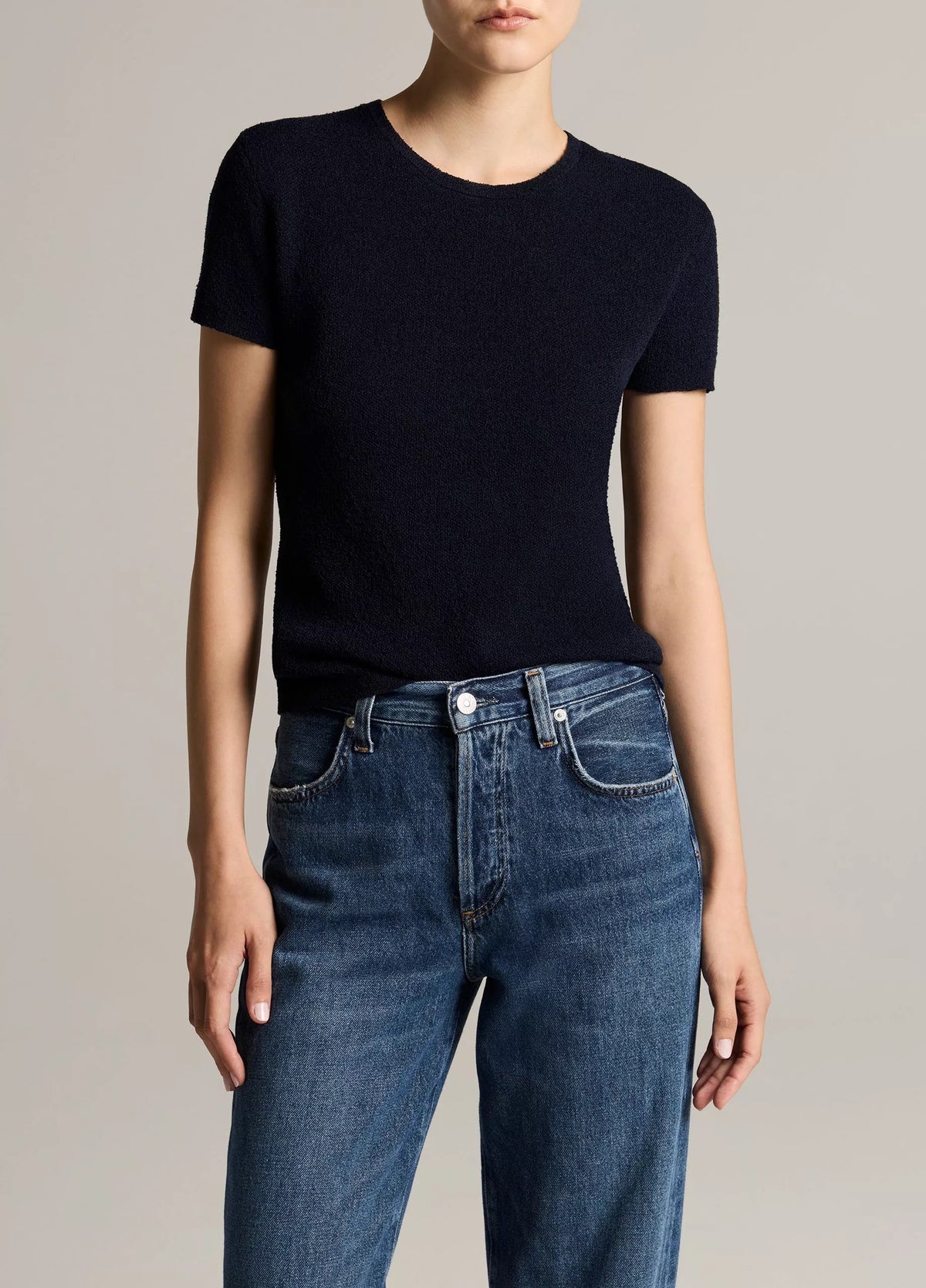 Woman wears a navy crew and jeans