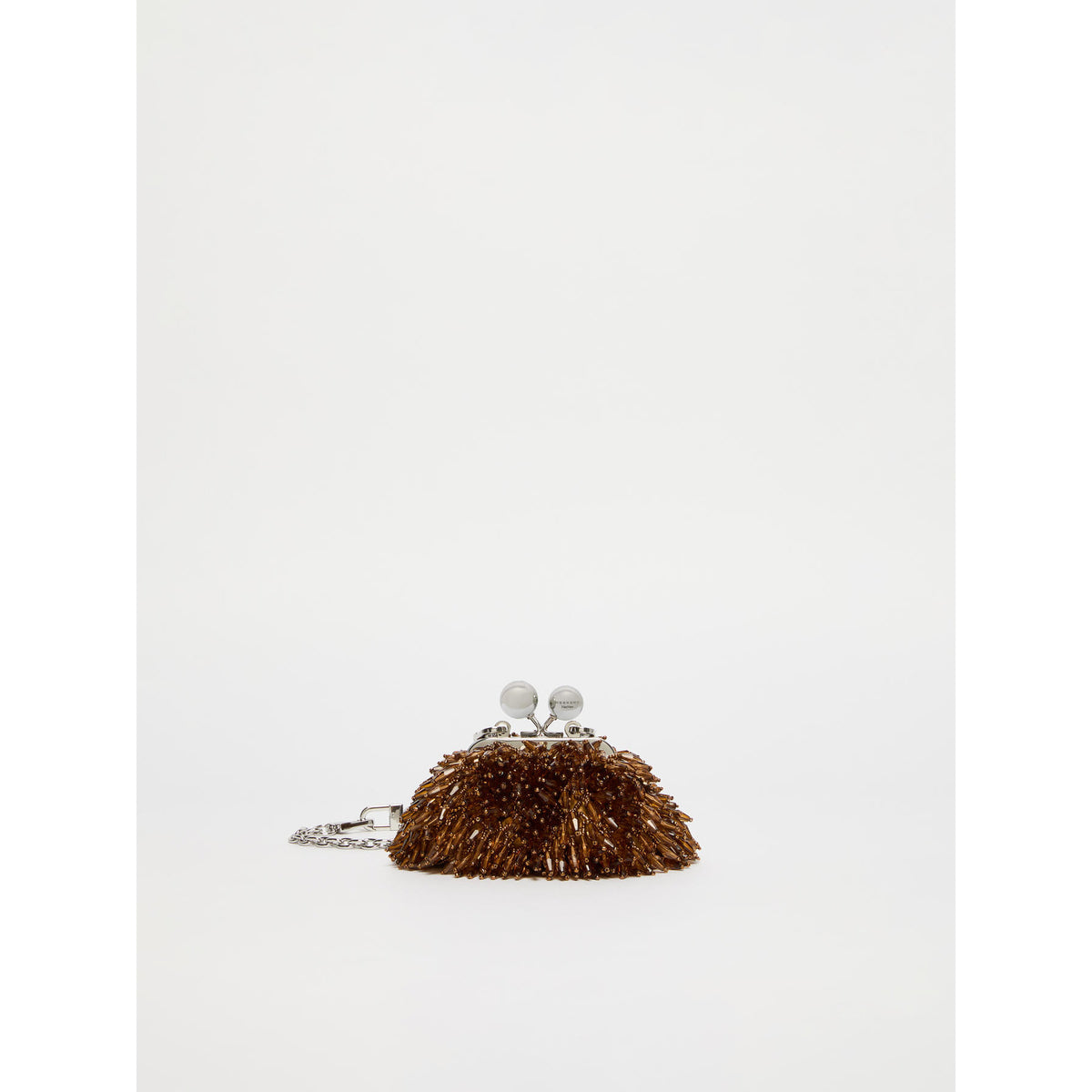 Small brown handbag with decorative elements on a white background