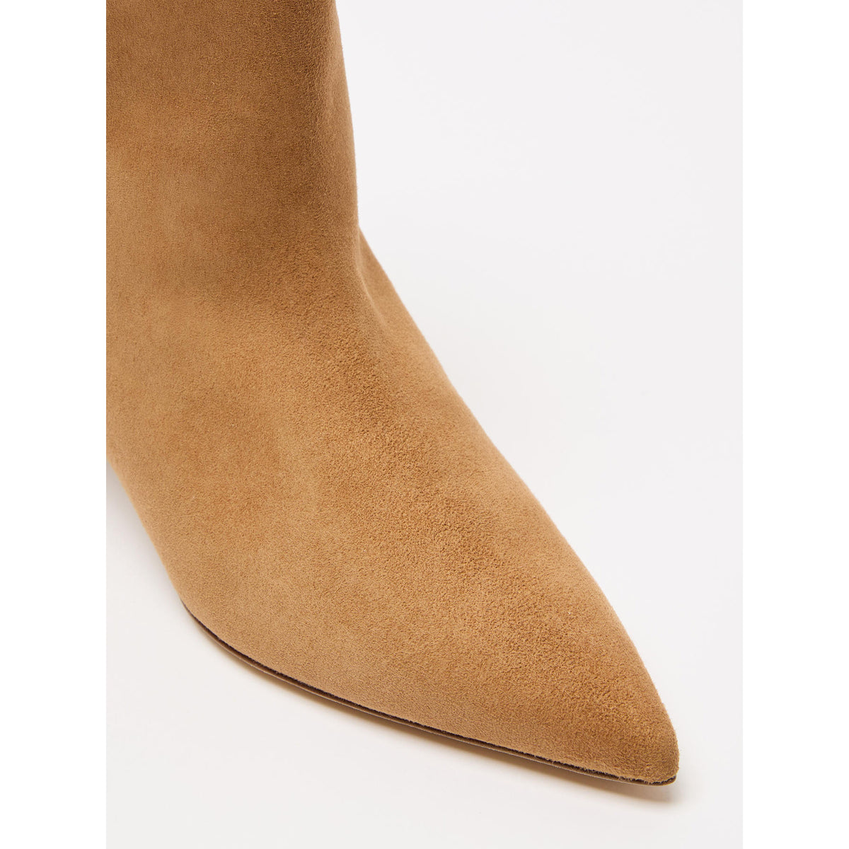 Close-up of a tan suede ankle boot on a white background