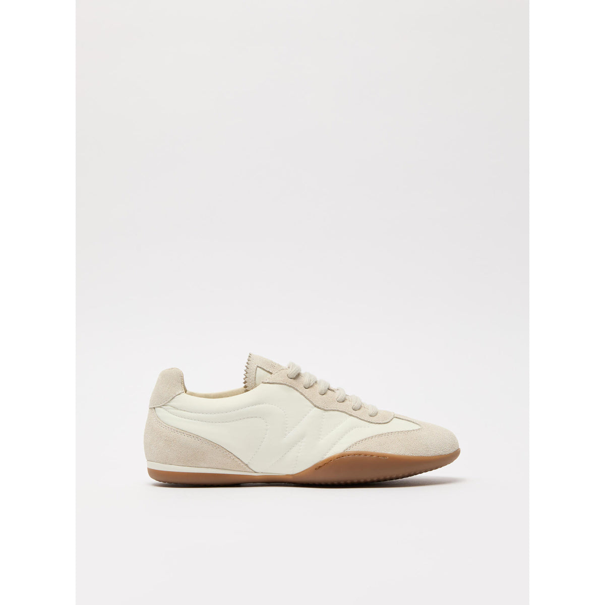 White sneaker with brown sole on a white background