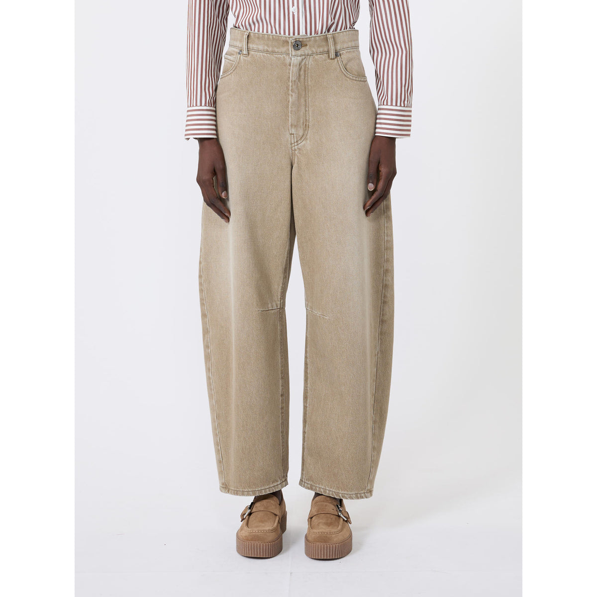 Person wearing beige wide-leg jeans and a striped shirt on a white background