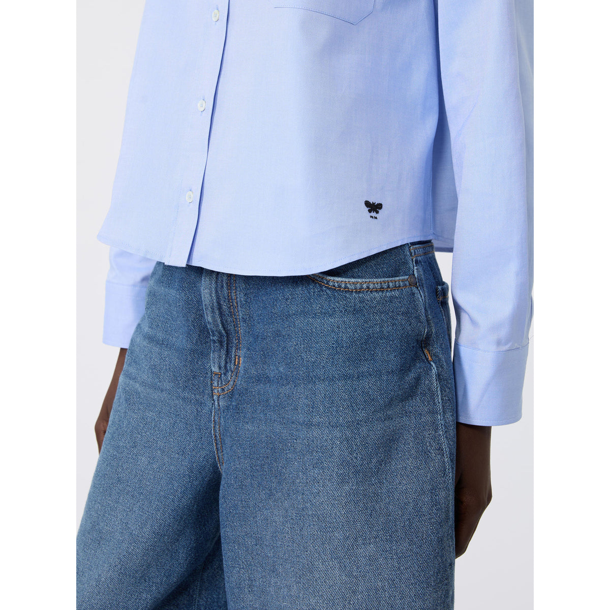 Light blue shirt and blue jeans on a white background