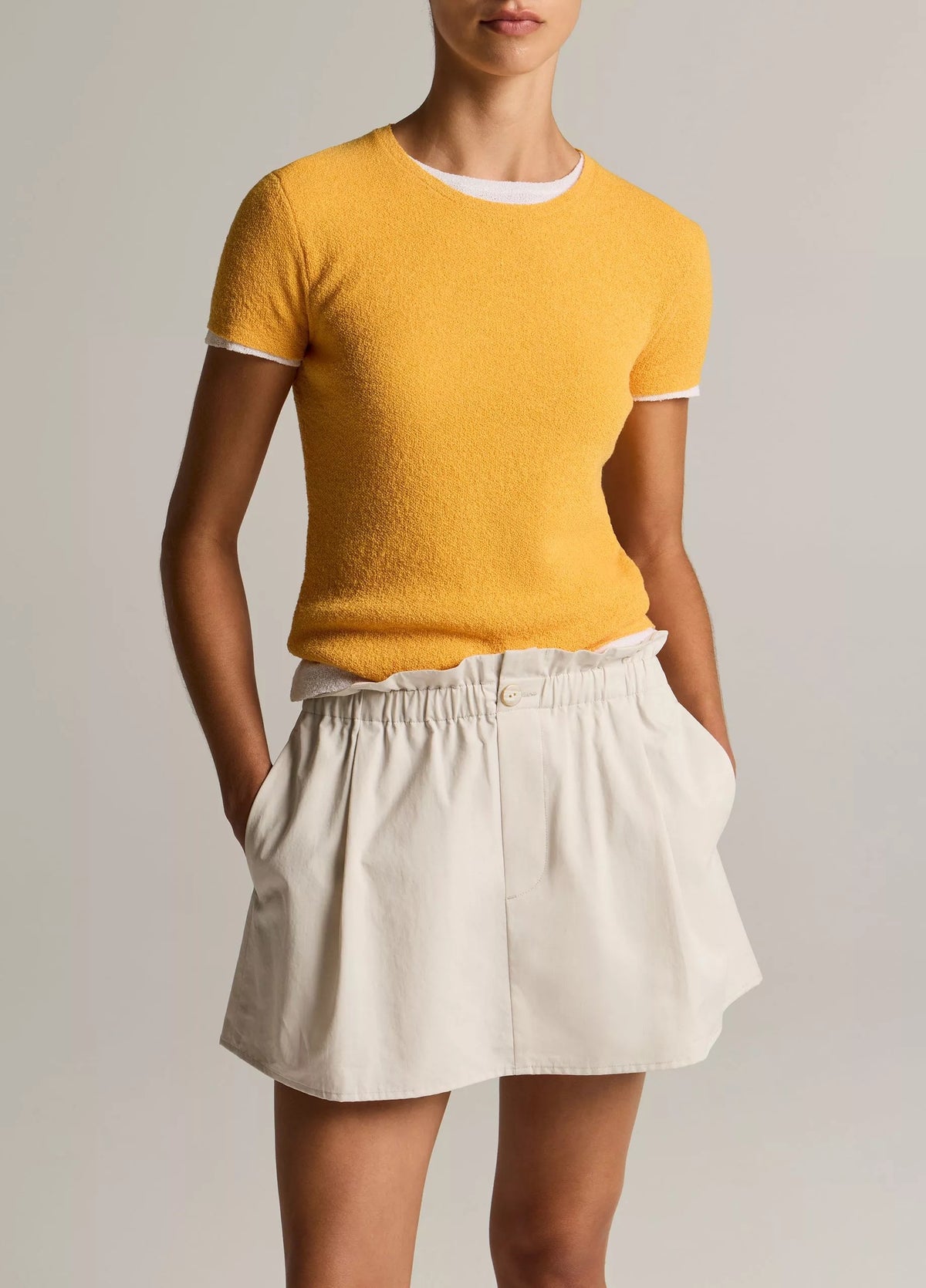 model wears yellow tee