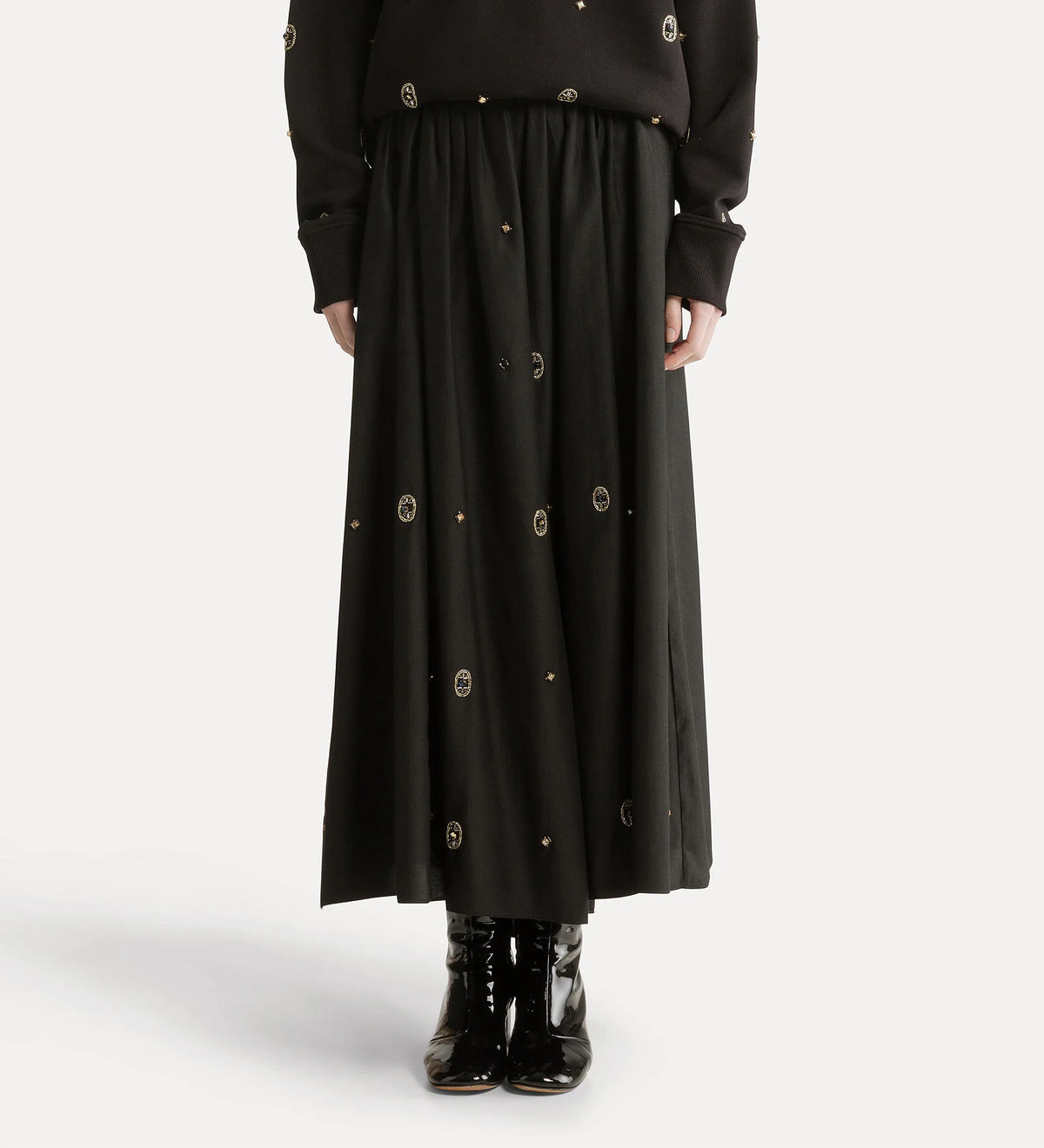 Black long skirt with button details on a white background