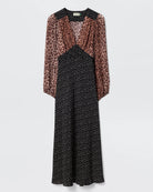 Dress with leopard print sleeves and black polka dot bodice on a white background