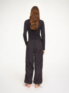 Person wearing a black outfit on a white background