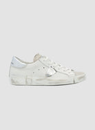 White sneaker with silver accents on a white background