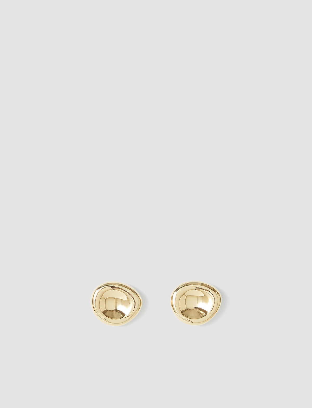 Pair of gold earrings on a light gray background