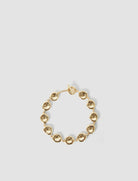 Gold bracelet on a light gray background