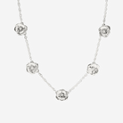 Silver necklace with floral pendants on a white background