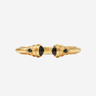 Gold bracelet with black gemstones on a white background