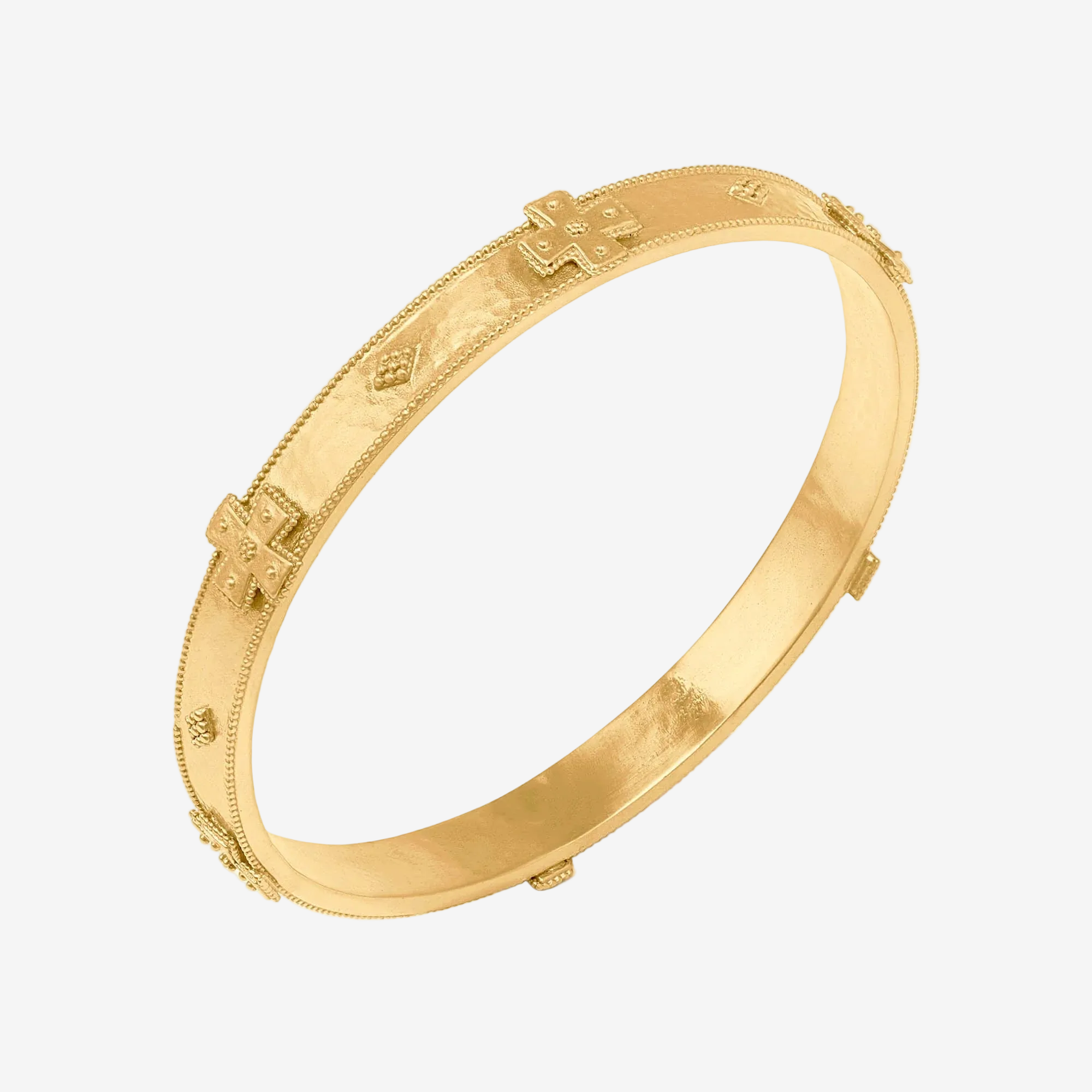 Gold bracelet with intricate designs on a white background