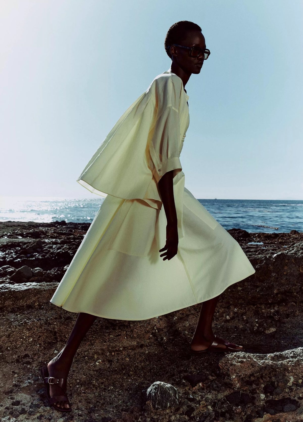 Model wears a yellow outfit by Vince