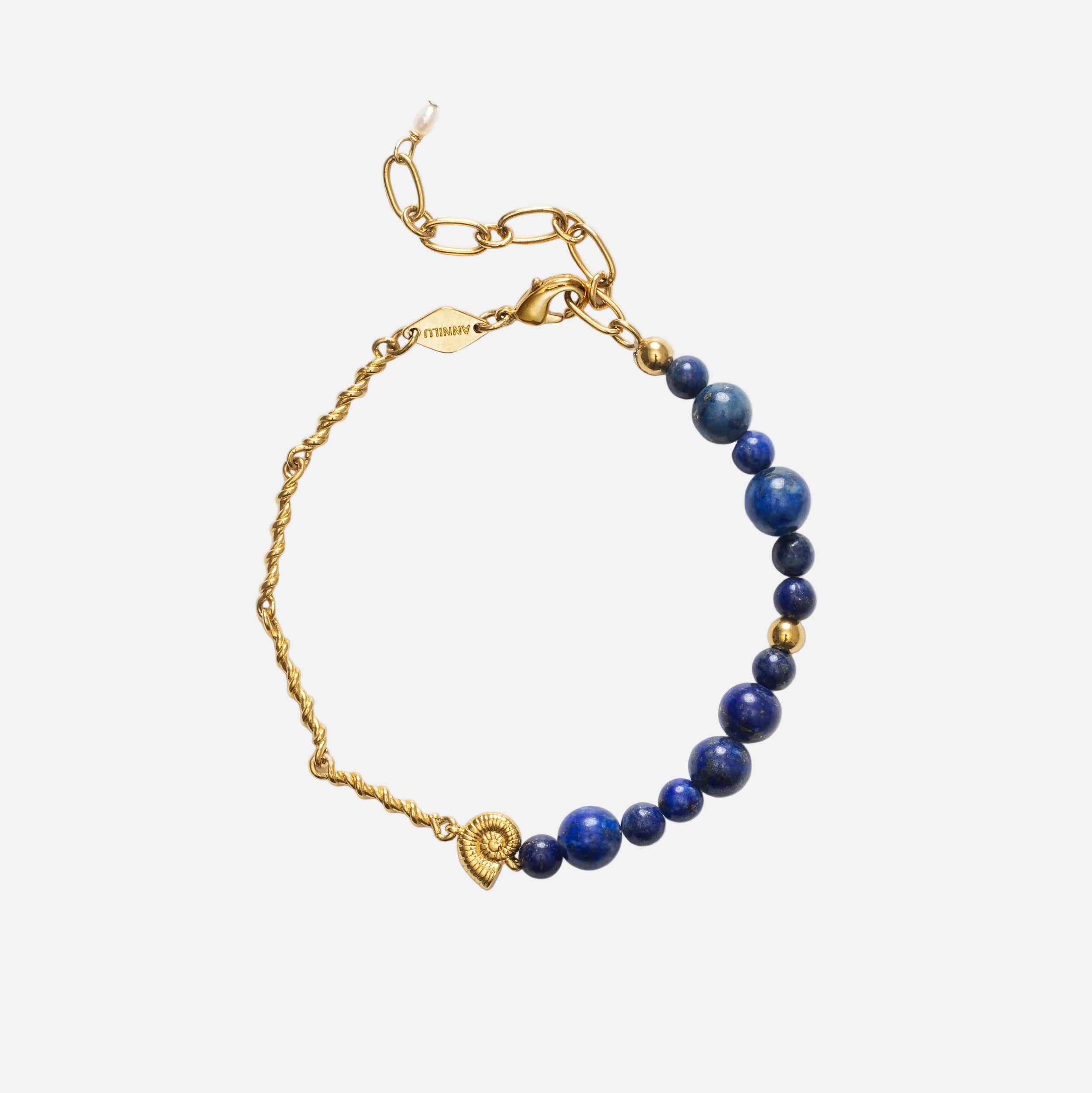 Gold bracelet with blue beads on a white background