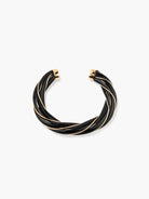 Black and gold bracelet on a white background