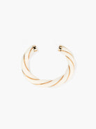 Gold cuff bangle on a white background