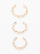 Three gold bangles on a white background
