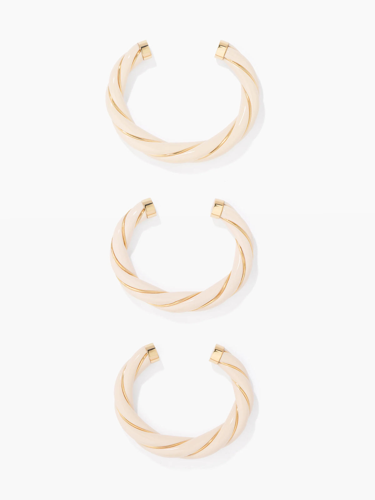 Three gold bangles on a white background