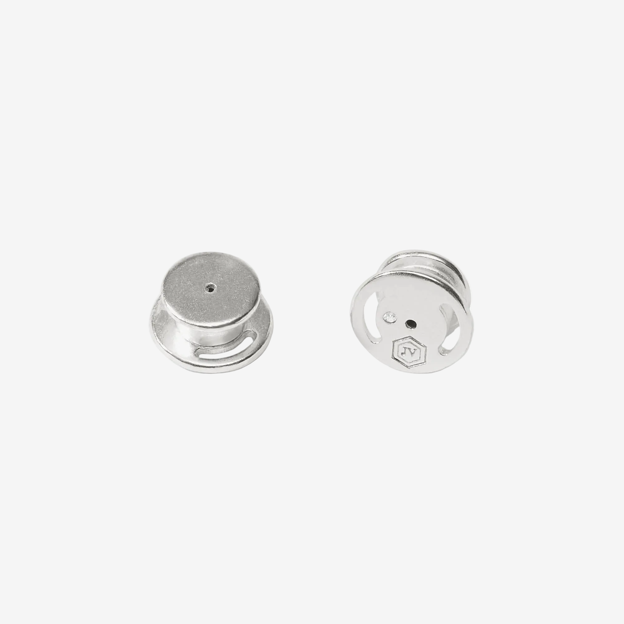 Two silver earrings on a white background