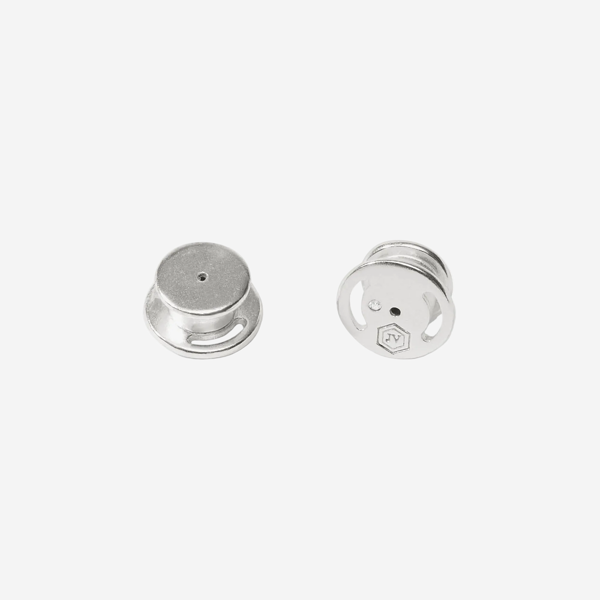 Two silver earrings on a white background