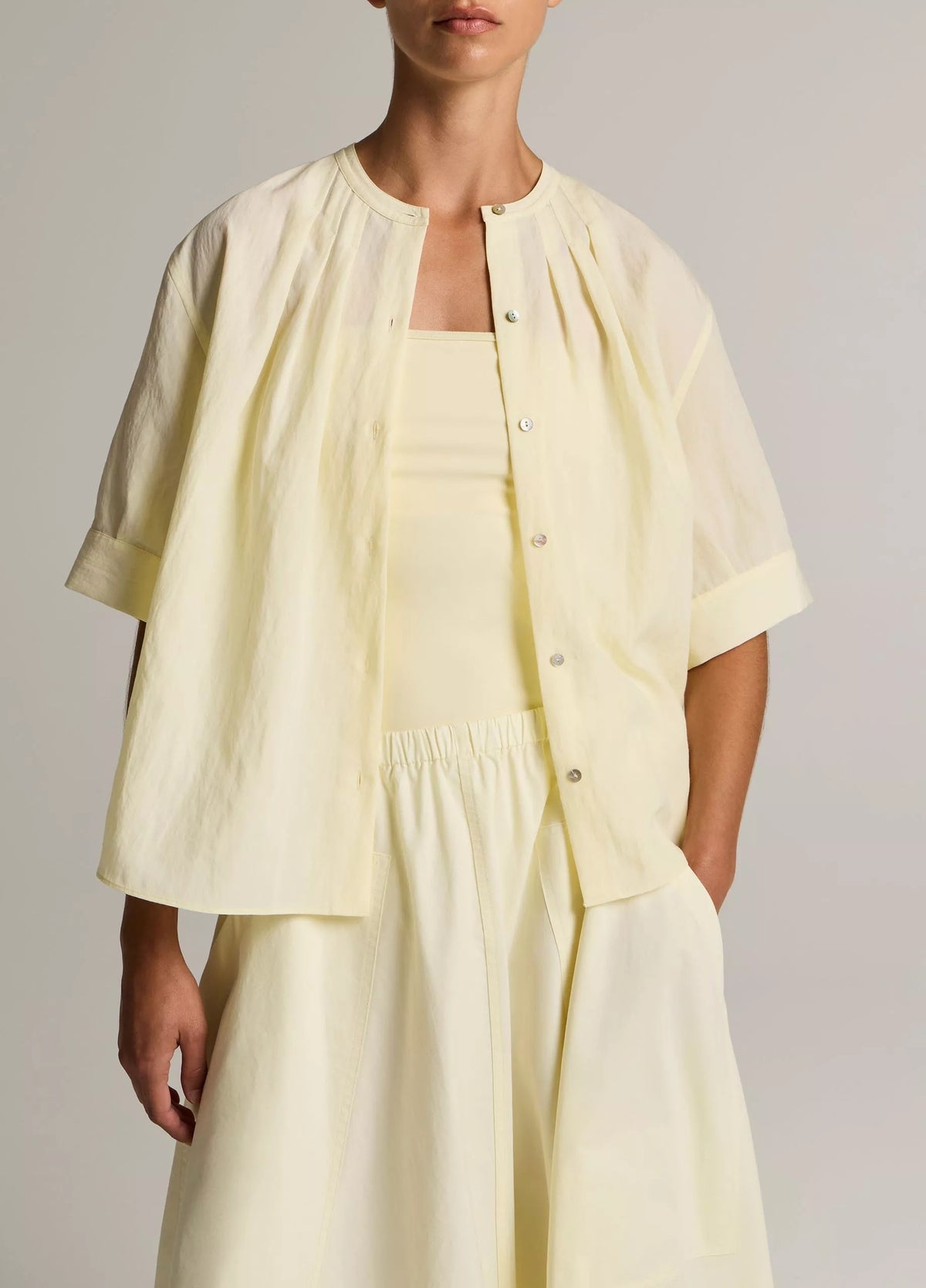 Model wears yellow shirt
