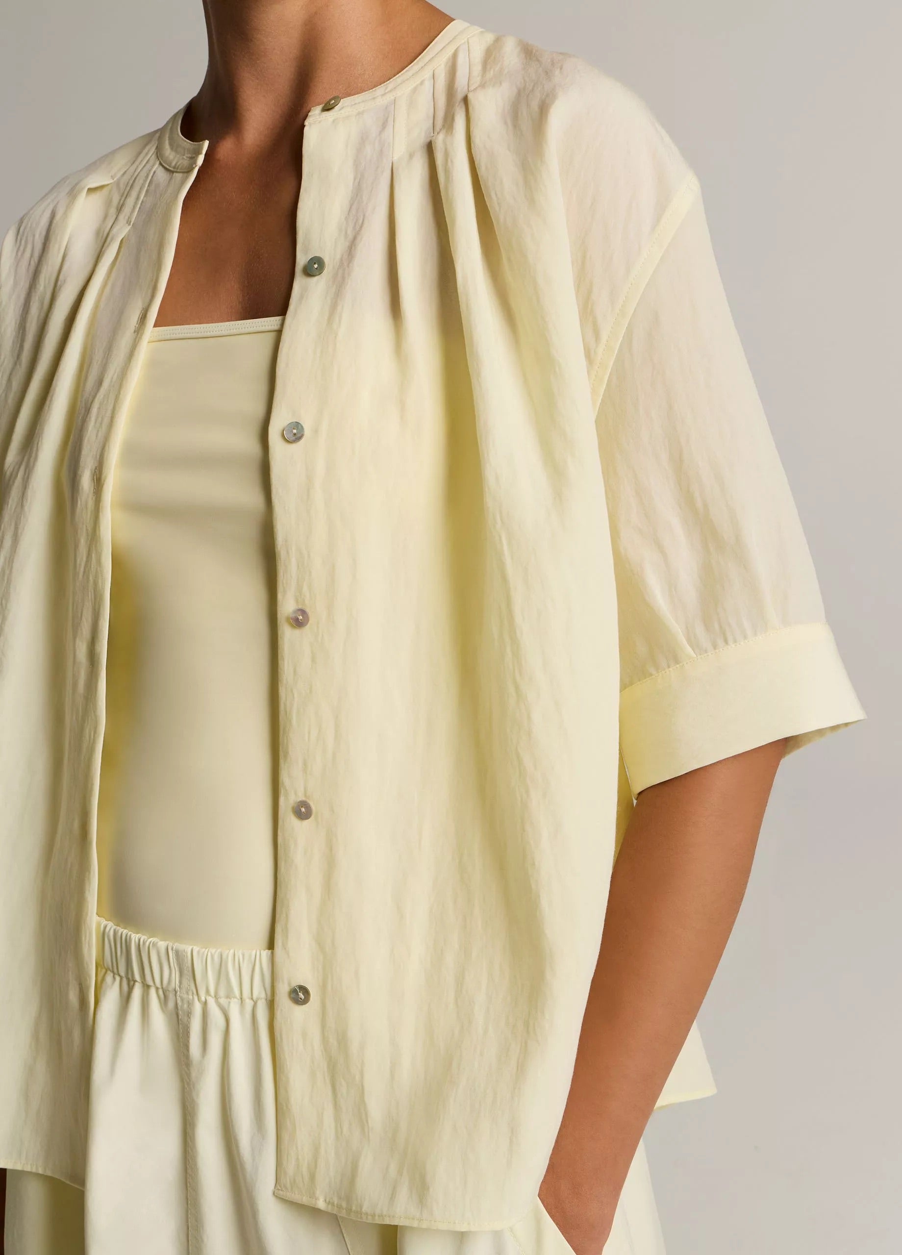 Model wears yellow shirt