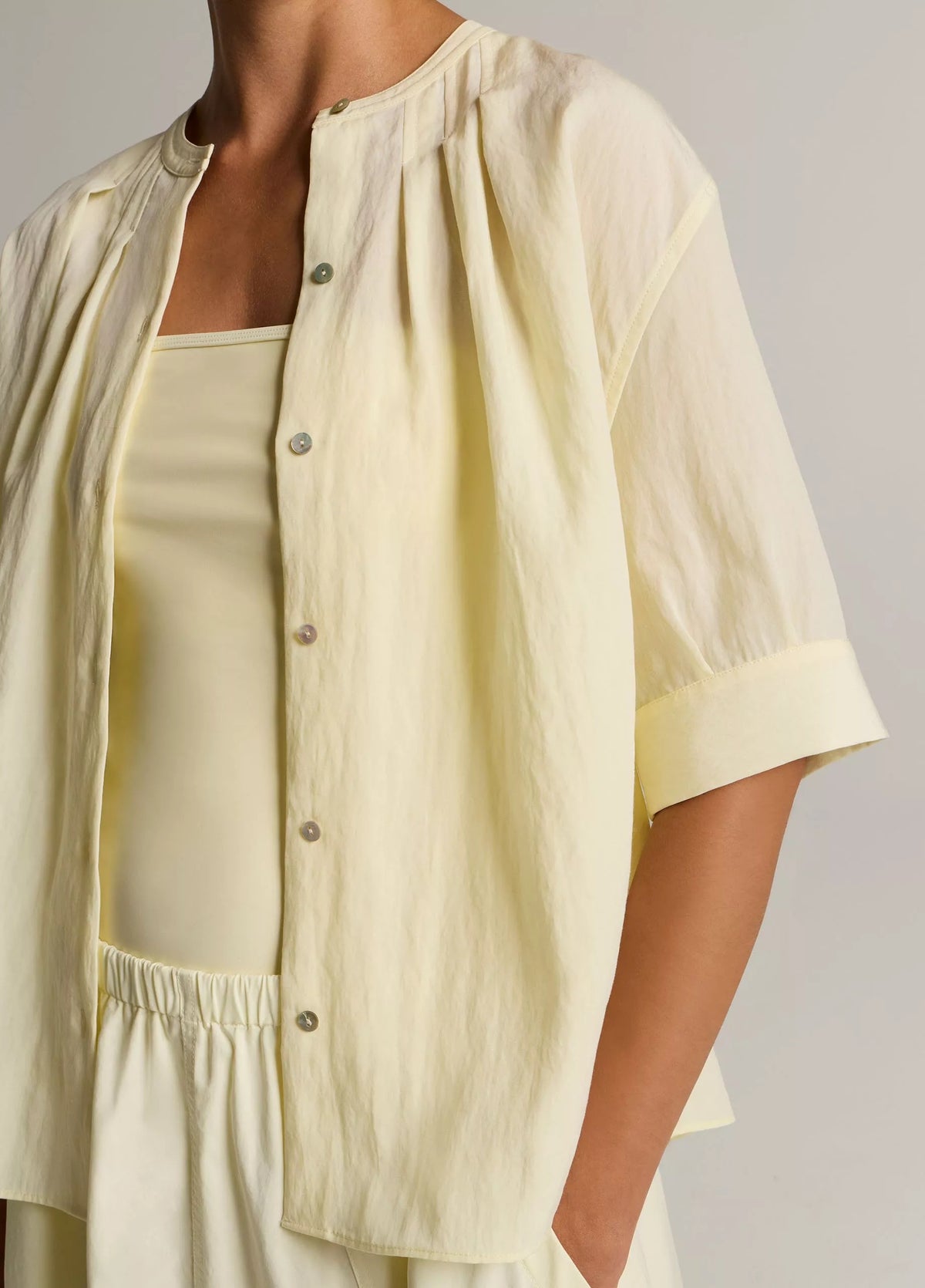 Model wears yellow shirt