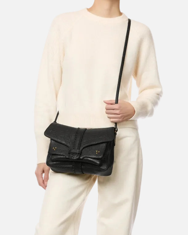 Person wearing a black leather bag with a white background
