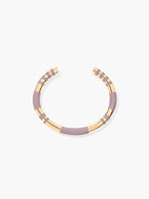Necklace with pale mauve and gold bands on a white background