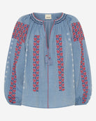Blue blouse with red and white floral embroidery on a white background