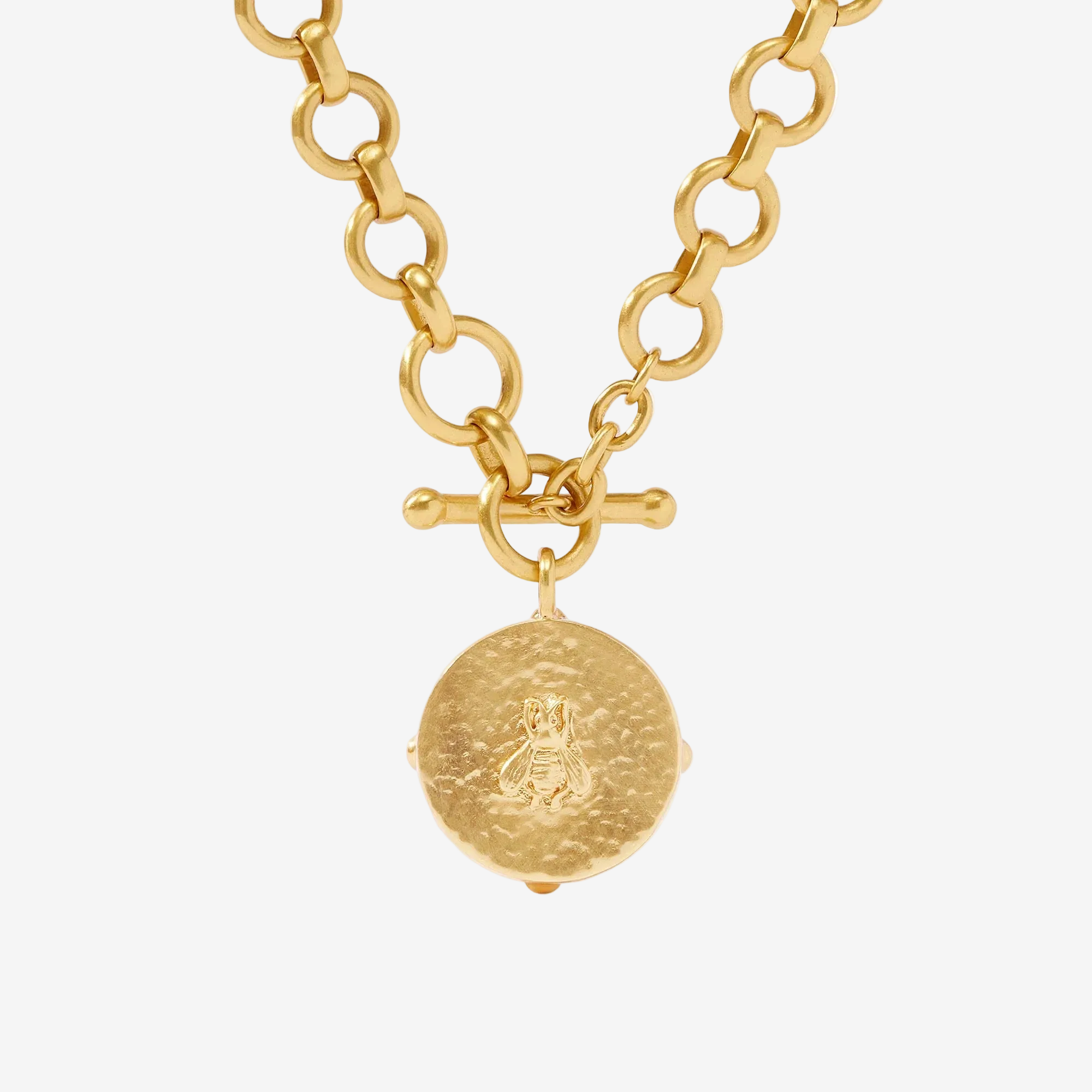 Gold necklace with a round pendant on a white background