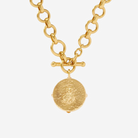 Gold necklace with a round pendant on a white background