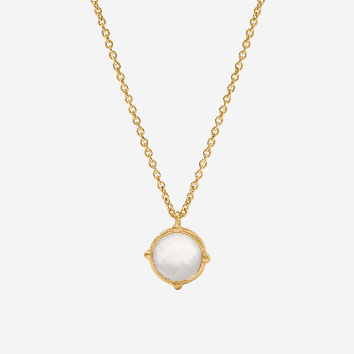 Gold necklace with a white pendant on a white background
