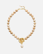 Pearl necklace with a gold clasp on a white background