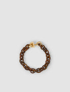 Brown chain bracelet with gold clasp on a light gray background