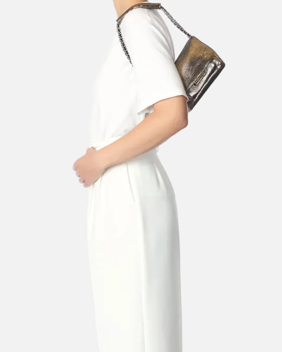 Person wearing a white dress holding a brown handbag on a white background