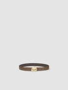 Brown belt with a gold buckle on a light gray background