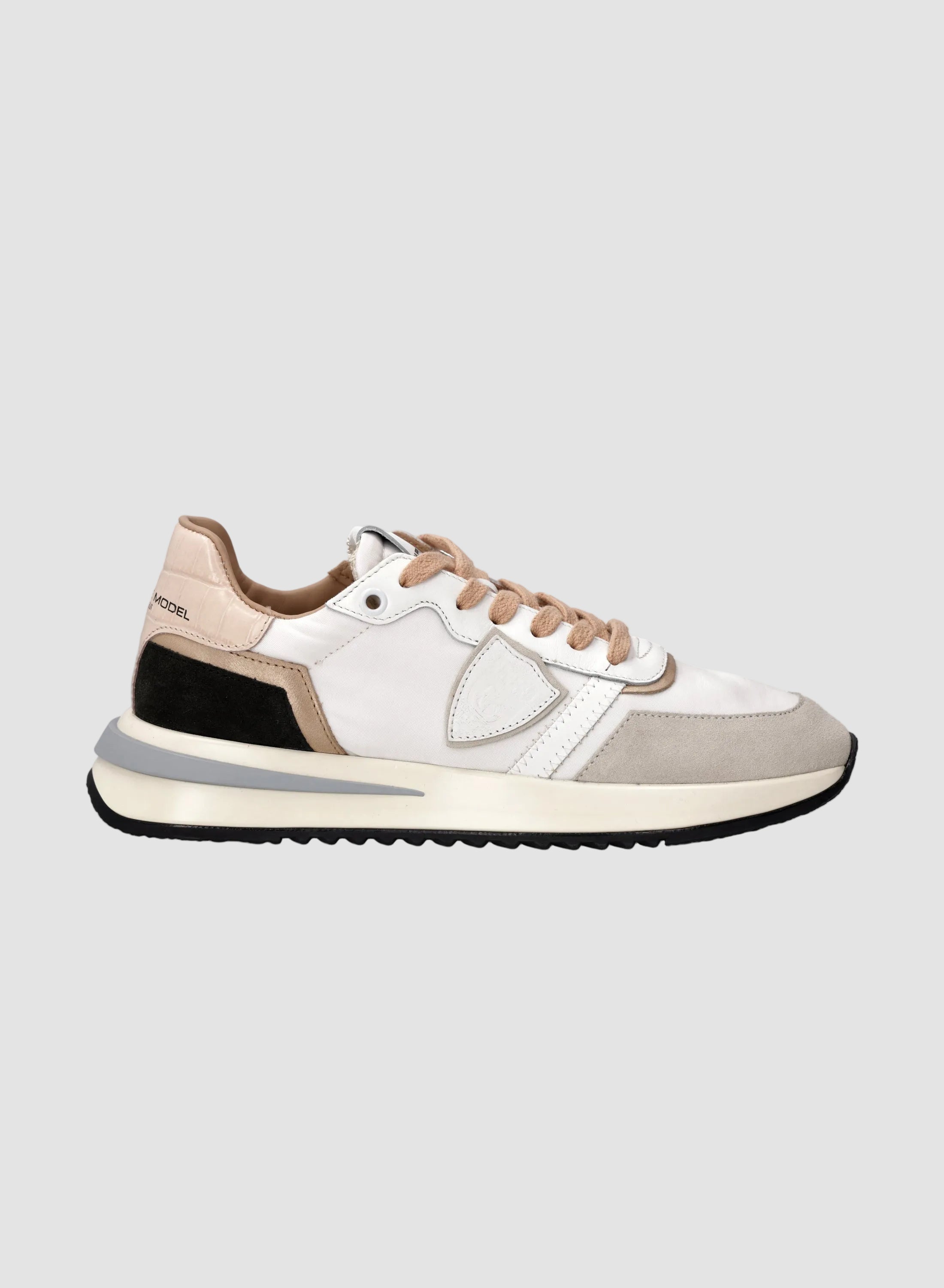 White sneaker with brown accents on a white background