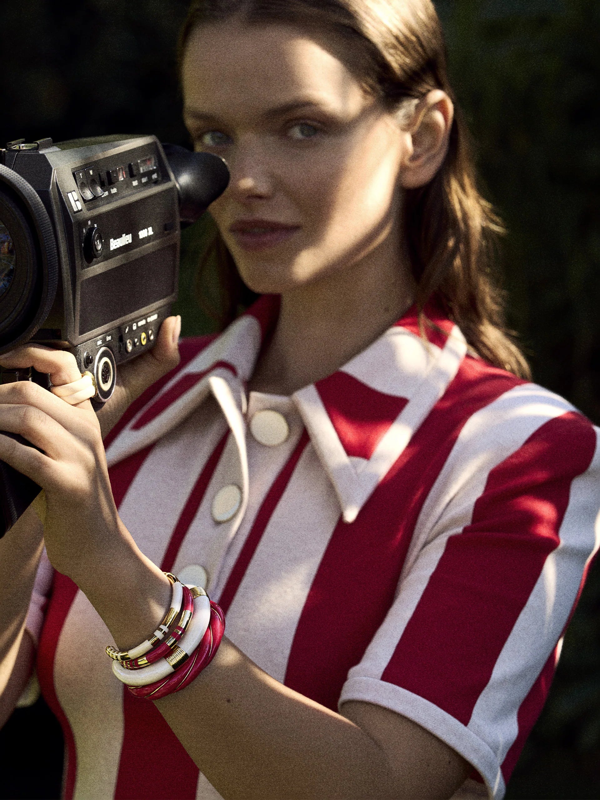 Woman holding a vintage video camera with a blurred background