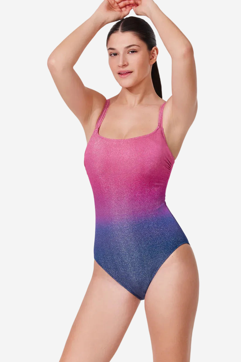 Woman wearing a pink and blue gradient swimsuit on a white background