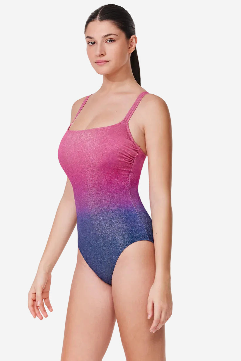 Woman wearing a pink to blue gradient swimsuit on a white background