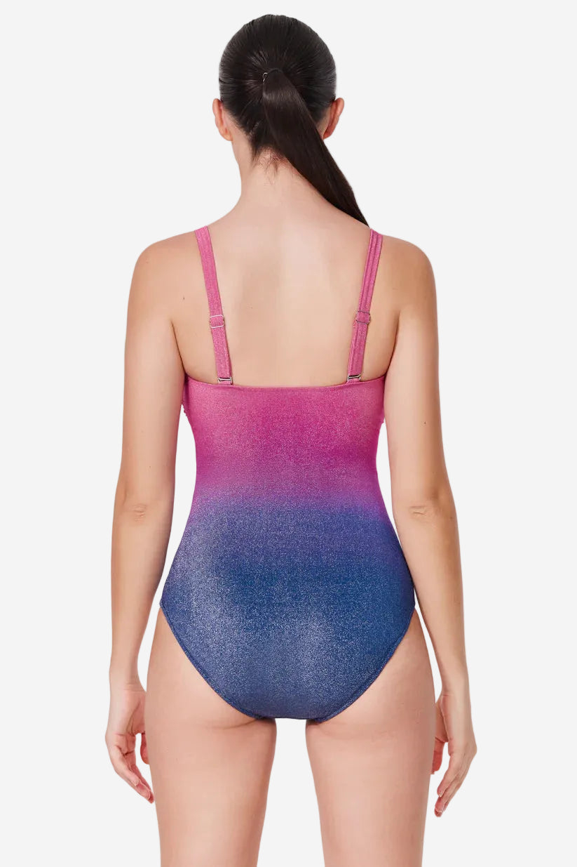 Woman wearing a gradient swimsuit with pink top and blue bottom on a white background