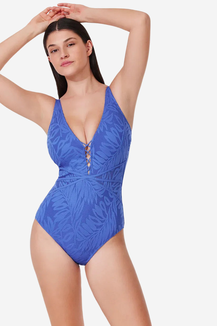 Woman wearing a blue one-piece swimsuit on a white background