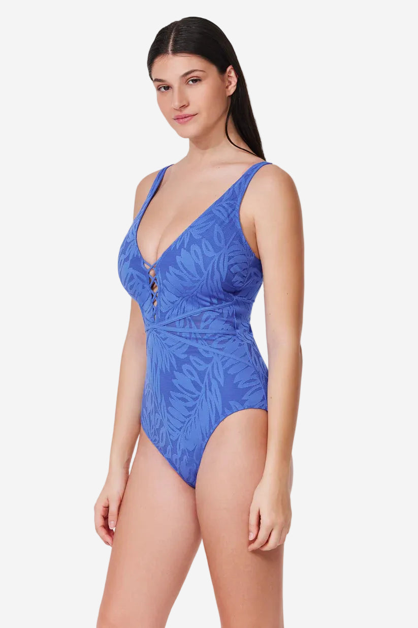 Woman wearing a blue swimsuit with a white background